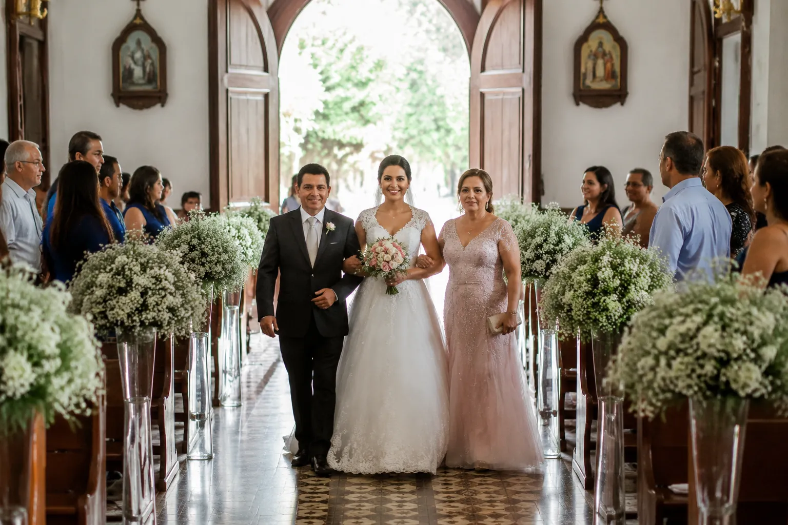 Wedding processional entering a Brazilian church with family members and attendants